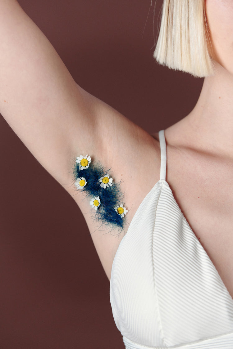 girls underarm showing blue hair and daisies