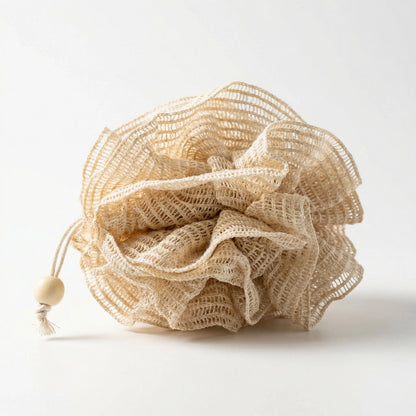 Beige ramie bath pouf with a wooden bead on a white background
