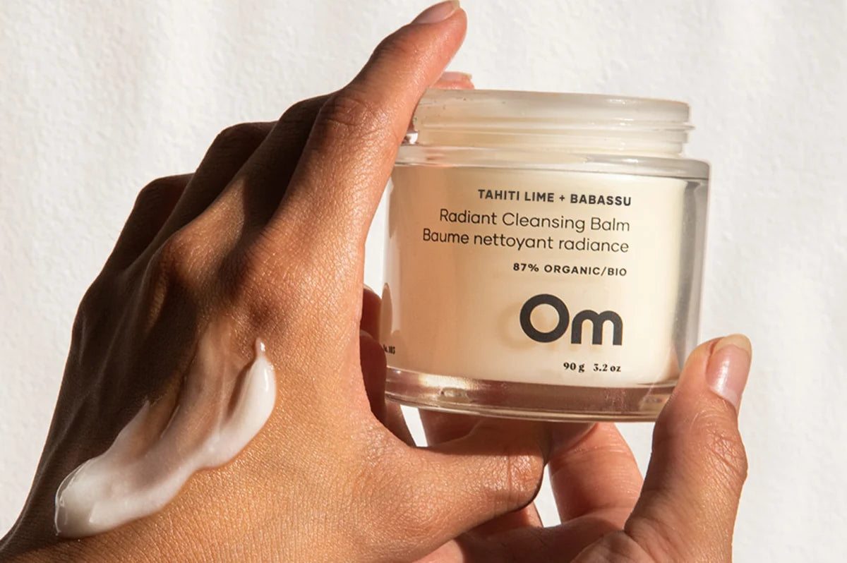 jar of cleansing balm in the hands of a woman